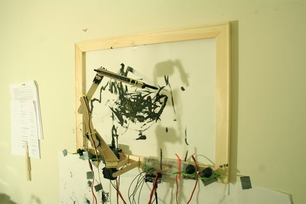 The IDA prototype: a salvaged picture frame with the articulated brush arm and electronics rigged to one side.